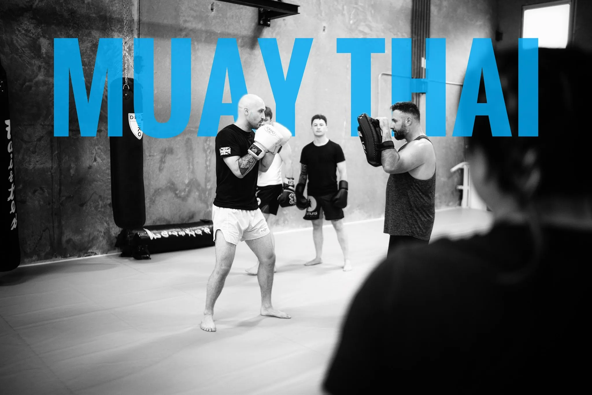 Coaches Kurt and Brandon running pad work drills during a Muay Thai class in Mission, BC